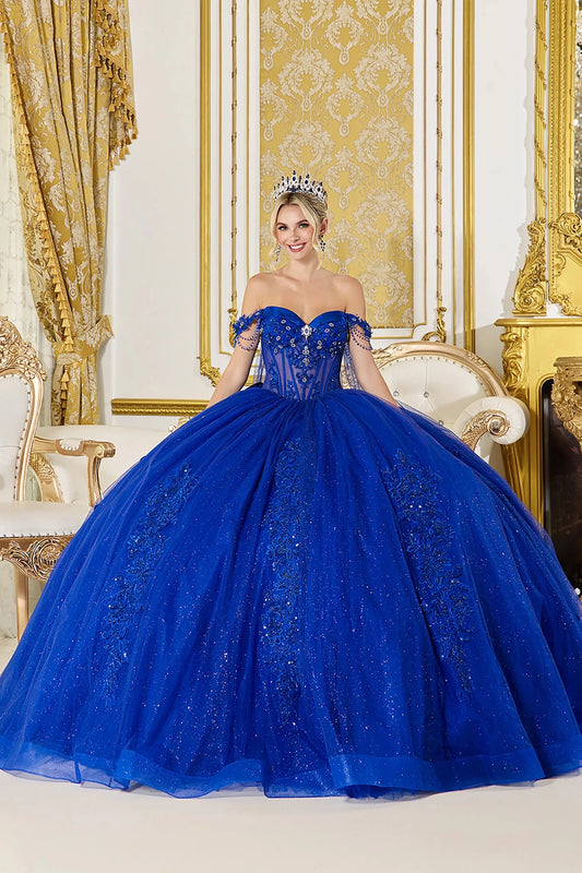 Woman in Royal blue strapless quinceañera ball gown with illusion corset and embroidered skirt.