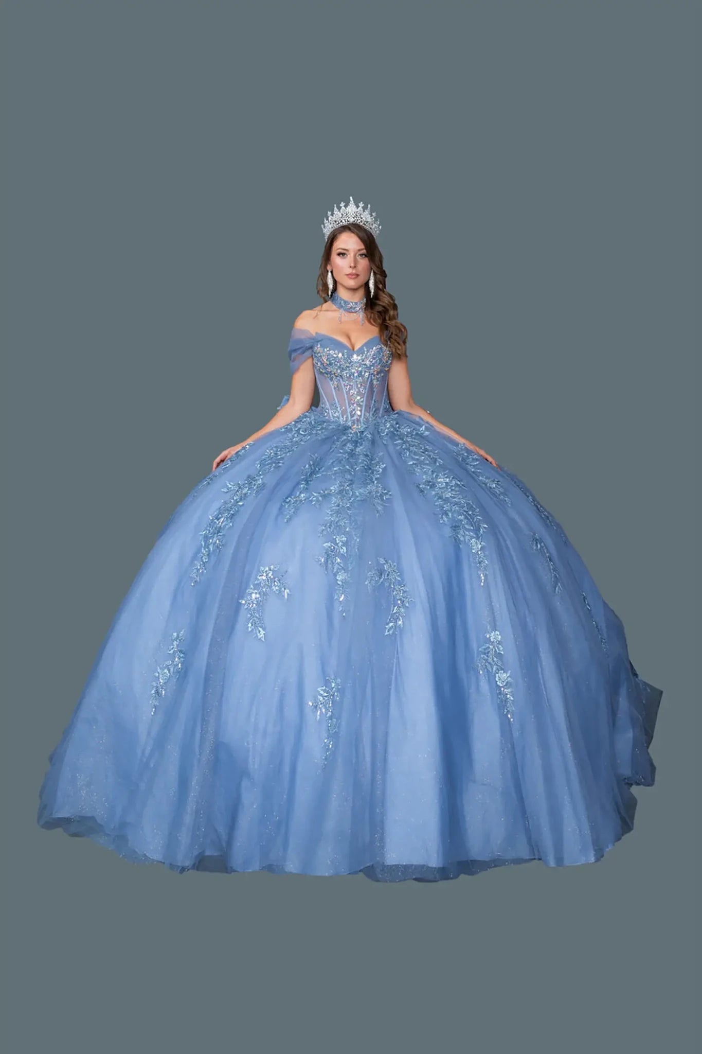 Front view of smoky blue quinceañera ball gown with off-the-shoulder sweetheart corset bodice, floral embroidery, and full layered glitter tulle skirt on a clean background