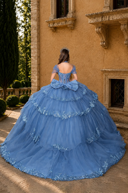 blue quinceañera dress with lace-up corset, oversized bow and tiered tulle skirt