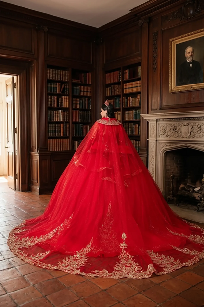 Woman back-facing in red off-shoulder ball gown quinceañera dress with detachable hooded cape, and cascading tulle skirt