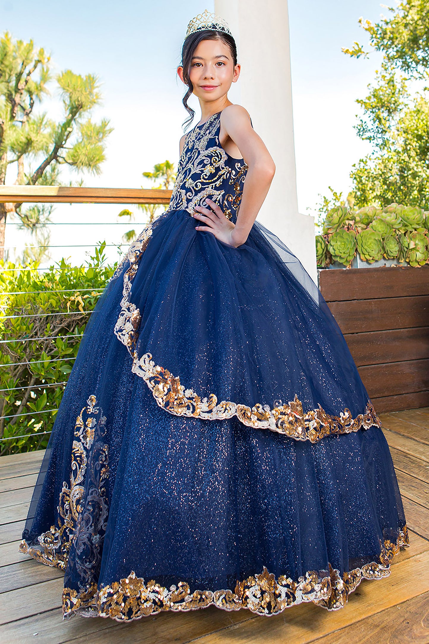 Elegant Glittered Two-tone Golden lace Satin Tulle with Patch Lace Wired Skirt Mini Quince Dress - side view of girl wearing dress and crown looking into the camera with one hand on hip