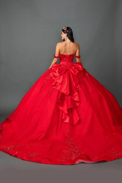 Woman standing back-facing in red ball gown with lace-up closure, embellished sweetheart bodice, and cascading embellished skirt

