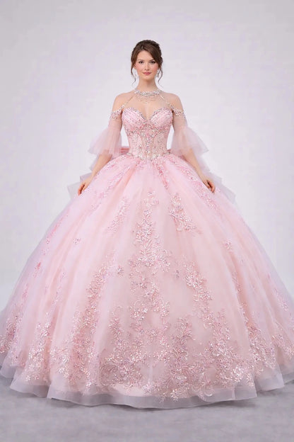 Woman standing front-facing in elegant blush ball gown with embellished corset bodice and voluminous full tulle skirt

