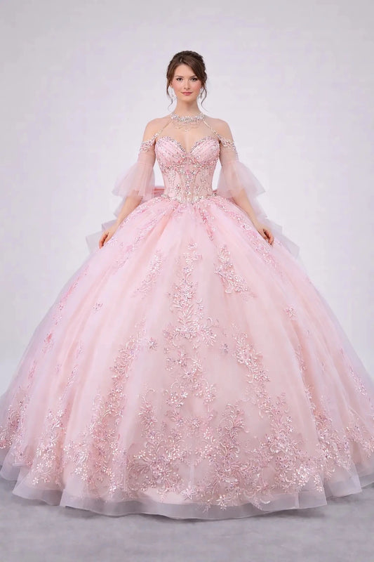 Woman standing front-facing in elegant blush ball gown with embellished corset bodice and voluminous full tulle skirt

