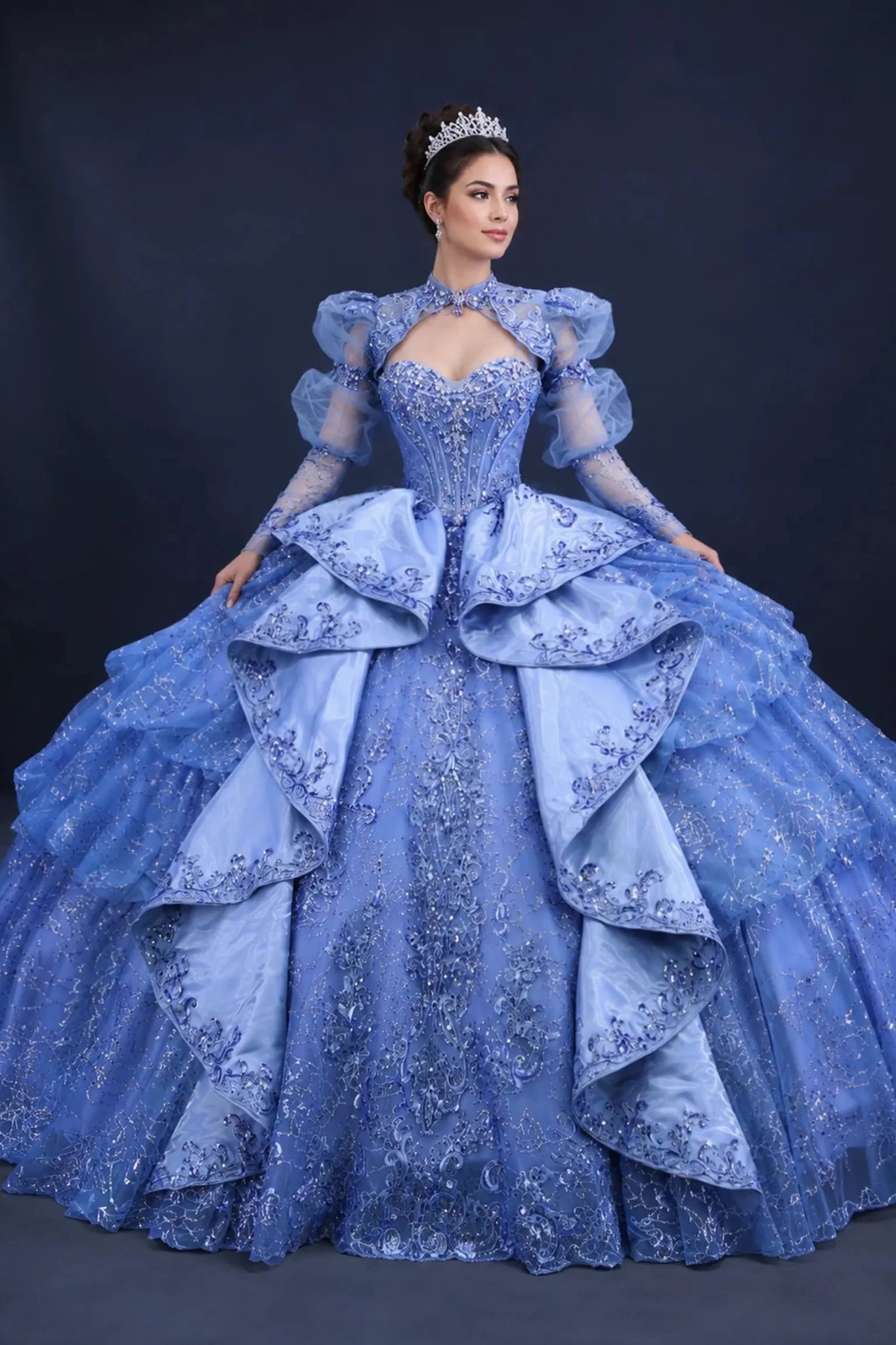 Front view of a woman wearing dusty blue quinceañera, high neckline, puff sleeves, embroidered corset