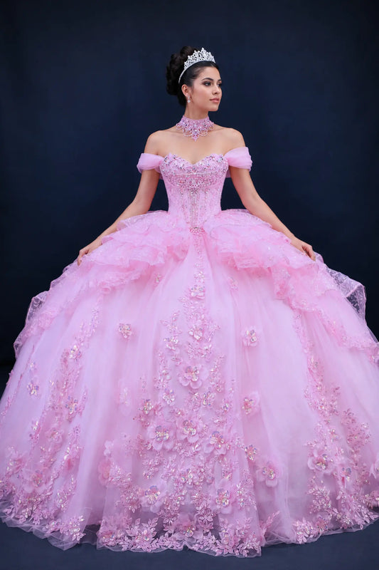 Full front view of a woman wearing a pink quinceañera dress with off-shoulder sweetheart neckline, floral applique details, beaded corset bodice, tiered ruffle skirt, and choker neck accent
