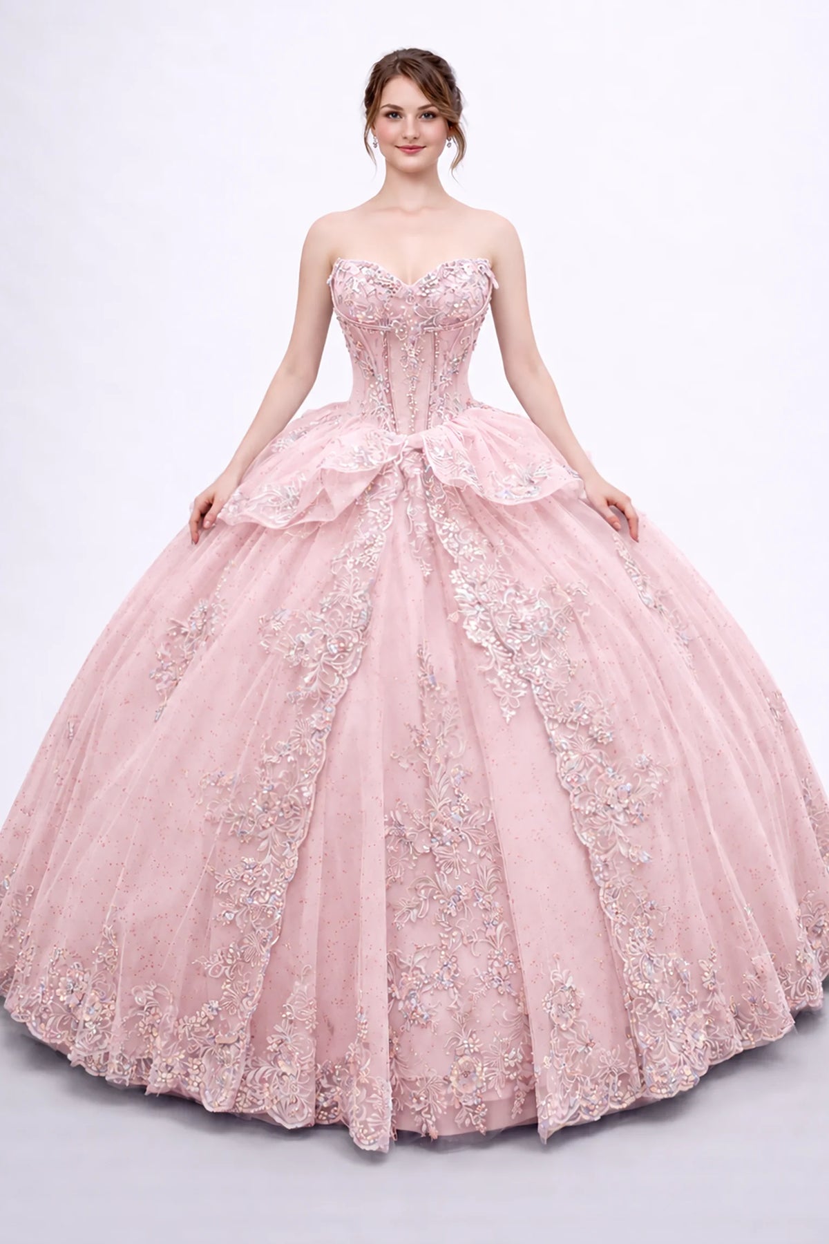 Front view of a Blush quinceañera dress with embroidered appliqués, sweetheart corset bodice and layered tulle overskirt