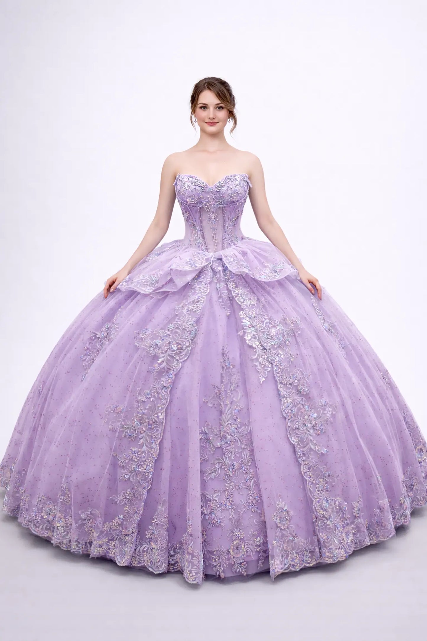 Front view of a woman wearing lilac quinceañera dress, strapless corset, embroidered appliques, layered tulle overskirt