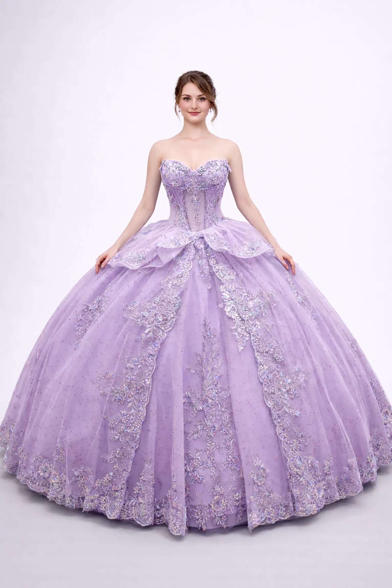 Front view of a woman wearing lilac quinceañera dress, strapless corset, embroidered appliques, layered tulle overskirt