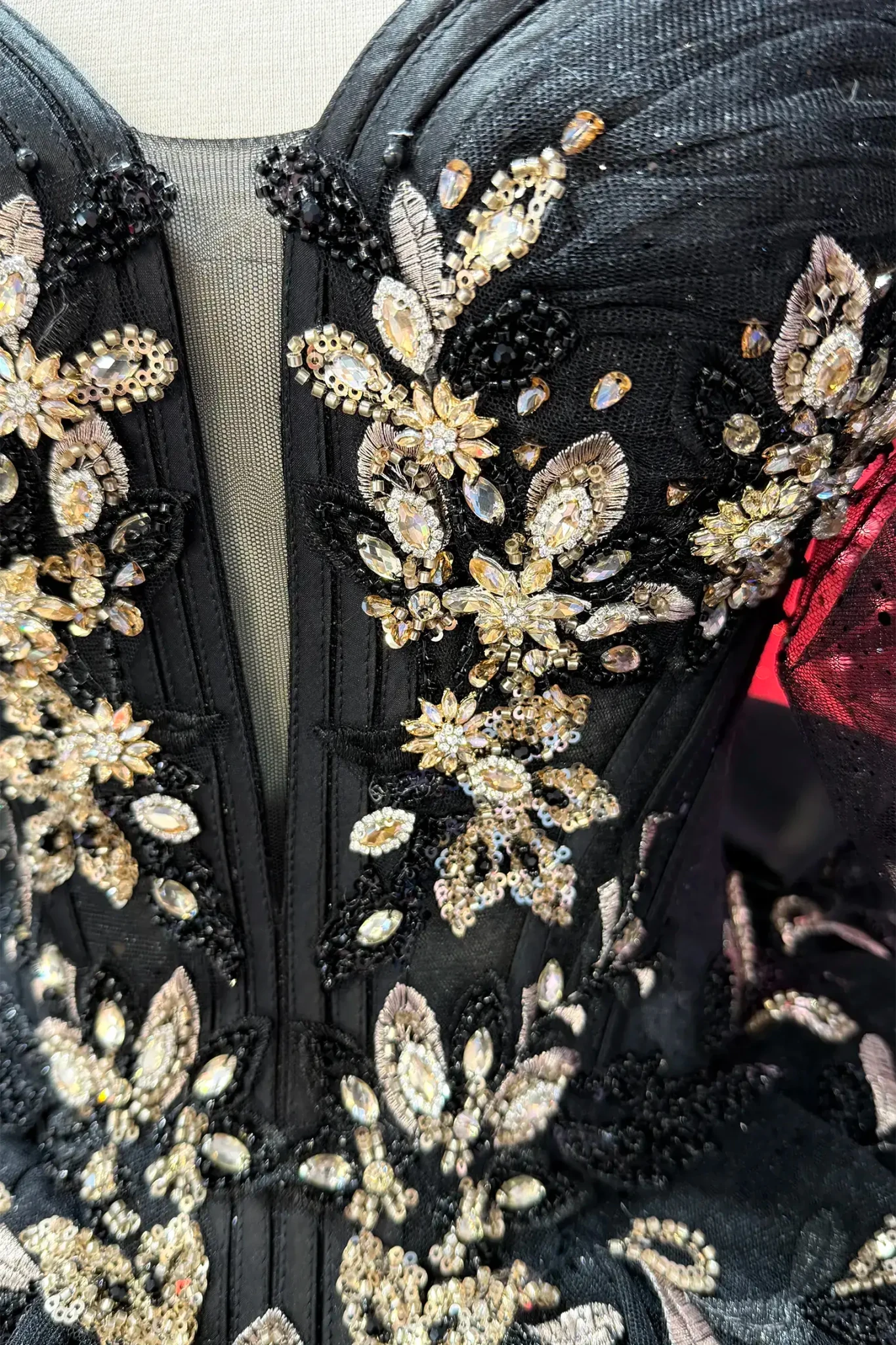 top of the black quince dress showing gold floral rhinestones
