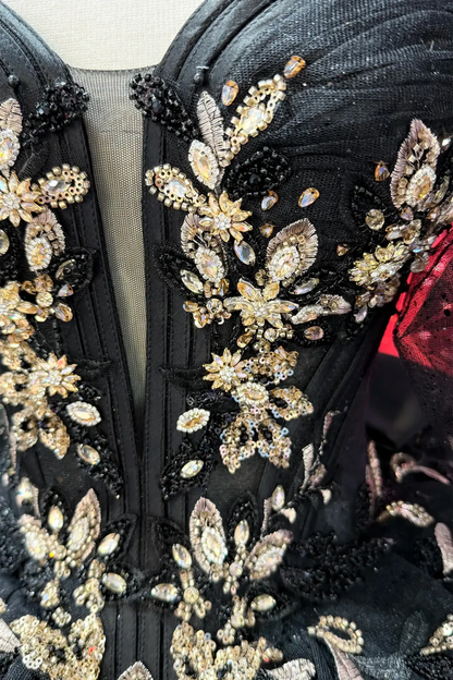 top of the black quince dress showing gold floral rhinestones