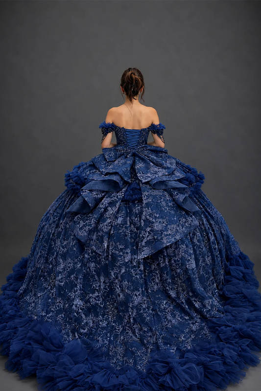 Back view of navy quinceañera dress with lace-up corset and tiered ruffle train