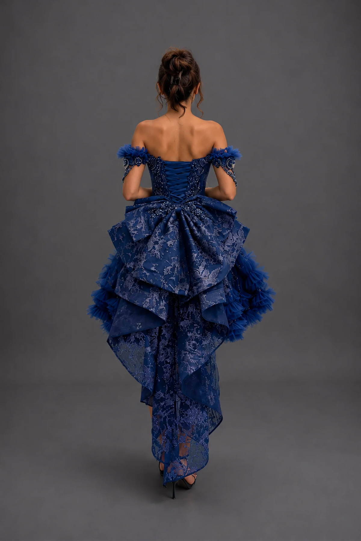 Back view of navy quinceañera dress showing lace-up bodice without the detachable overskirt