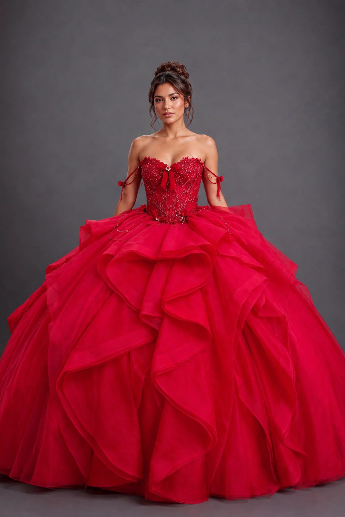 Front view of red quinceañera dress with beaded sweetheart bodice and tiered ruffle ball gown skirt