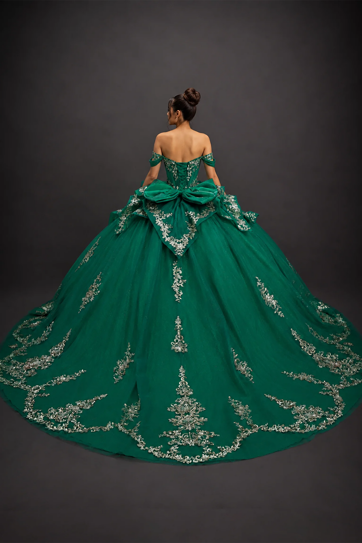 Back view of hunter green quinceañera dress with lace-up corset and ornate appliqué train