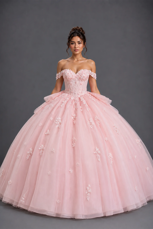 Front view of blush quinceañera dress with floral appliqué bodice and full tulle ball gown skirt