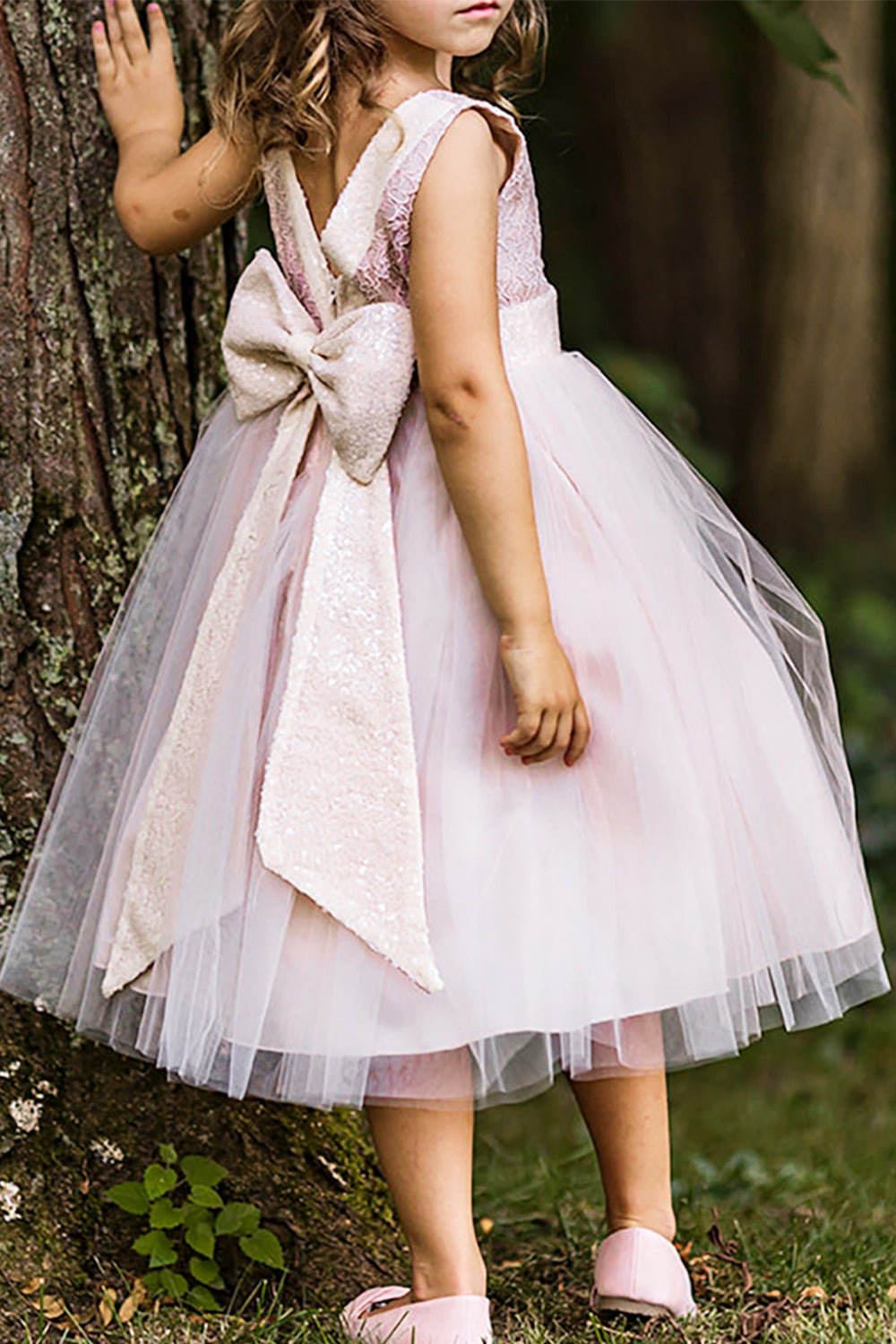A sleeveless lace tulle sequin V-back flower girl dress.