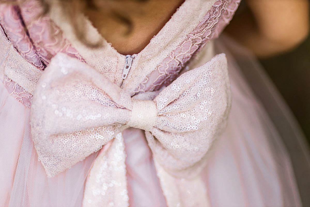 Sleeveless lace tulle flower girl dress with sparkling sequin bodice and flowing layered tulle skirt.