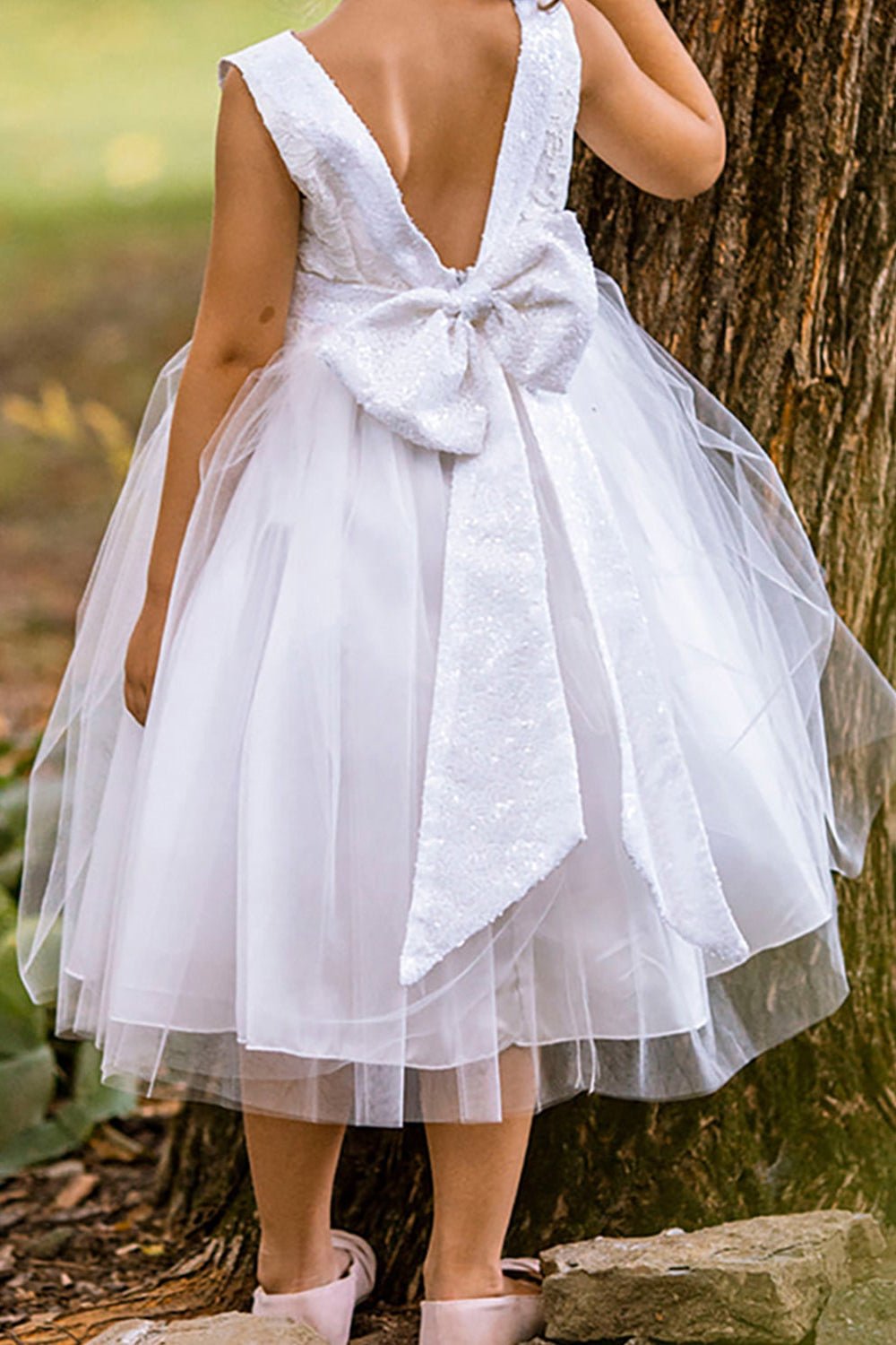Sleeveless lace tulle flower girl dress with sequin bodice and layered tulle skirt.