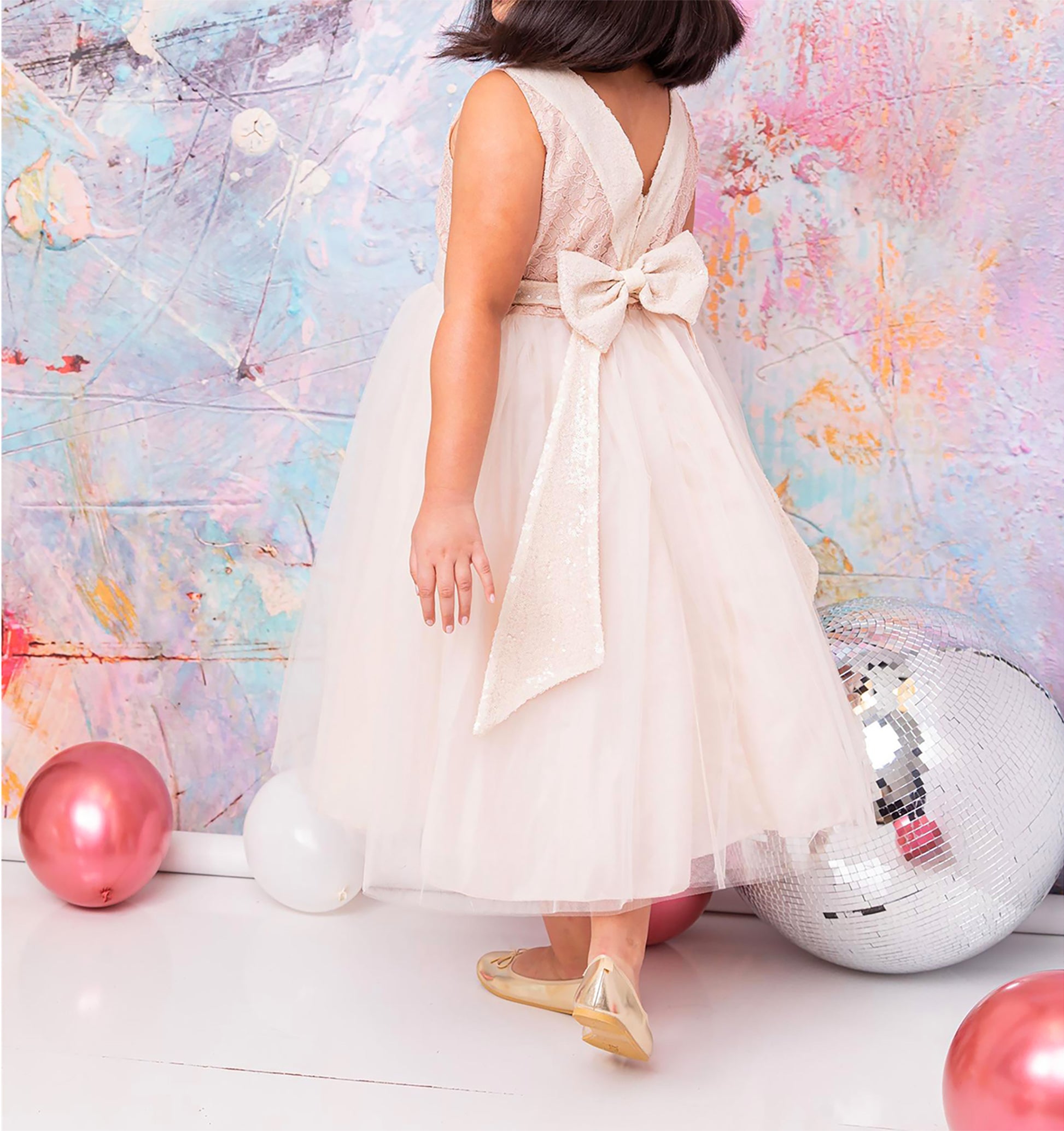Sleeveless lace tulle flower girl dress with sequin bodice and lace detailing.