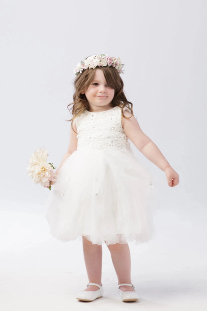 Soft ruffled tulle skirt shown on the off-white flower girl dress.