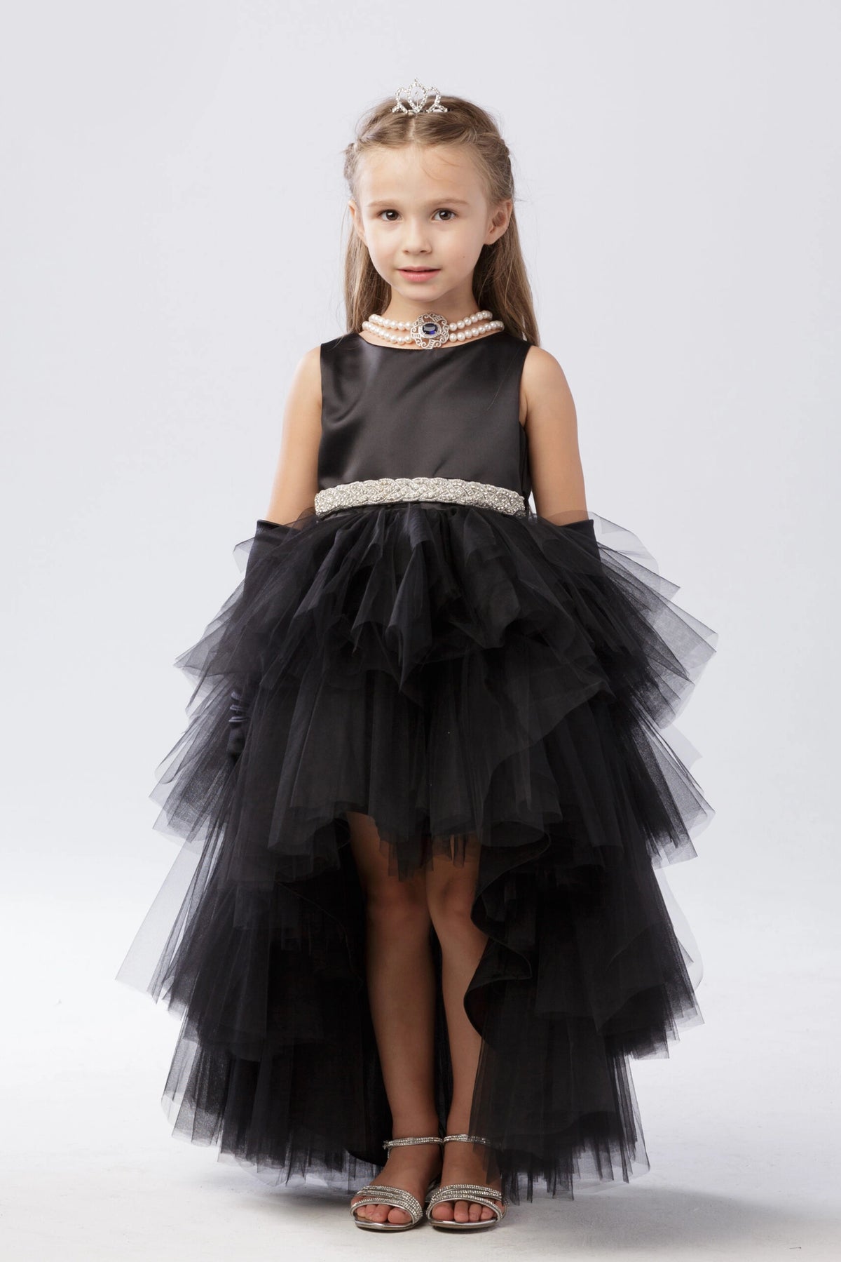 Black kids pageant dress featuring a satin bodice and layered high-low tulle.
