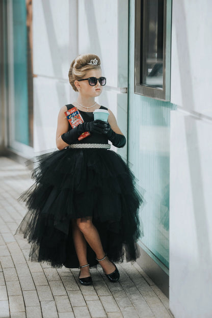 The Black kids pageant dress has a satin bodice and layered high-low tulle.