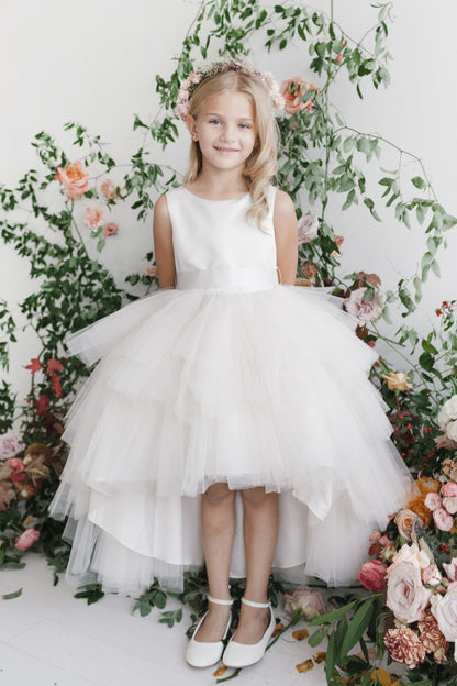 Ivory kids pageant dress featuring a satin bodice and layered high-low tulle.