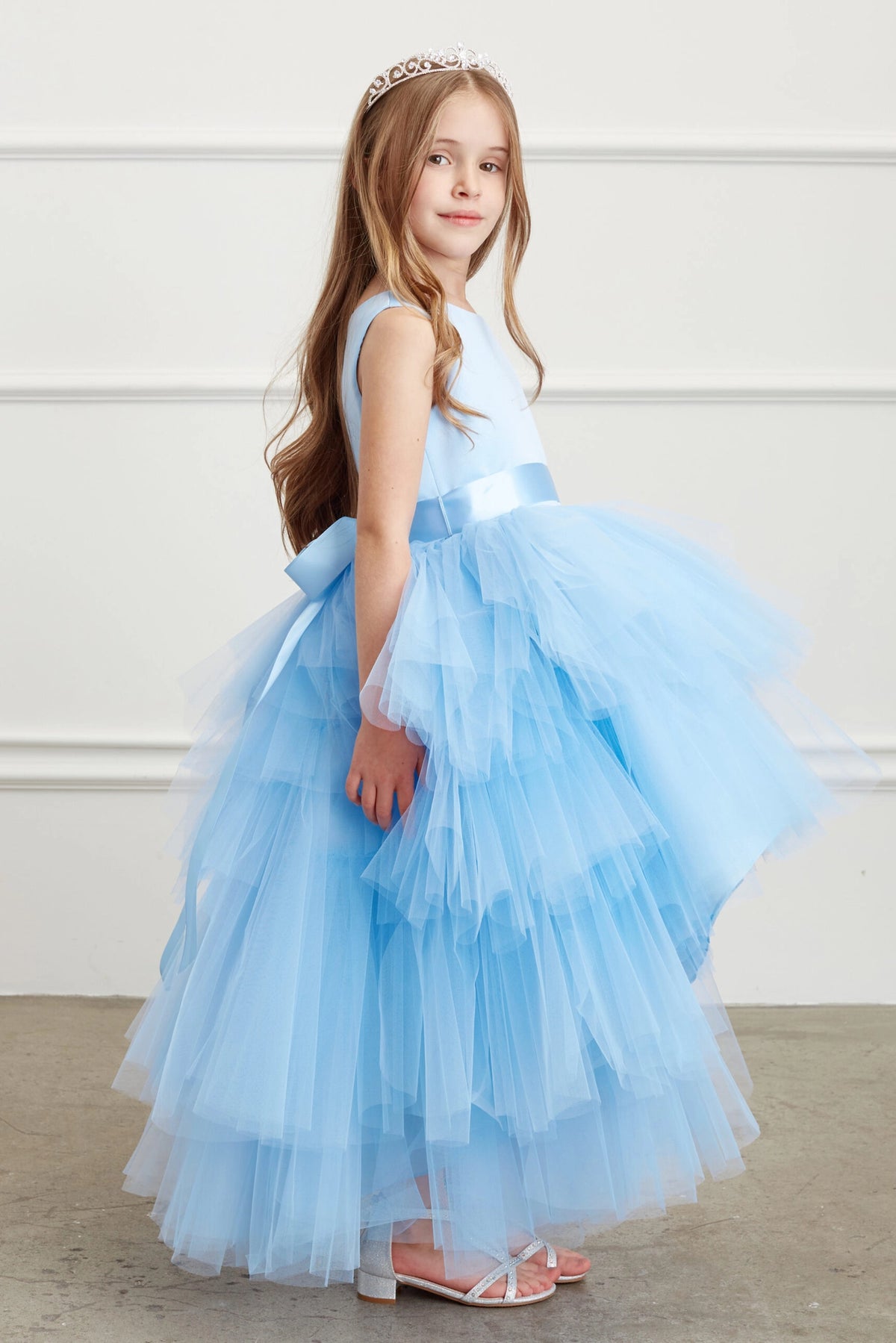 The Sky Blue kids pageant dress has a satin bodice and layered high-low tulle.
