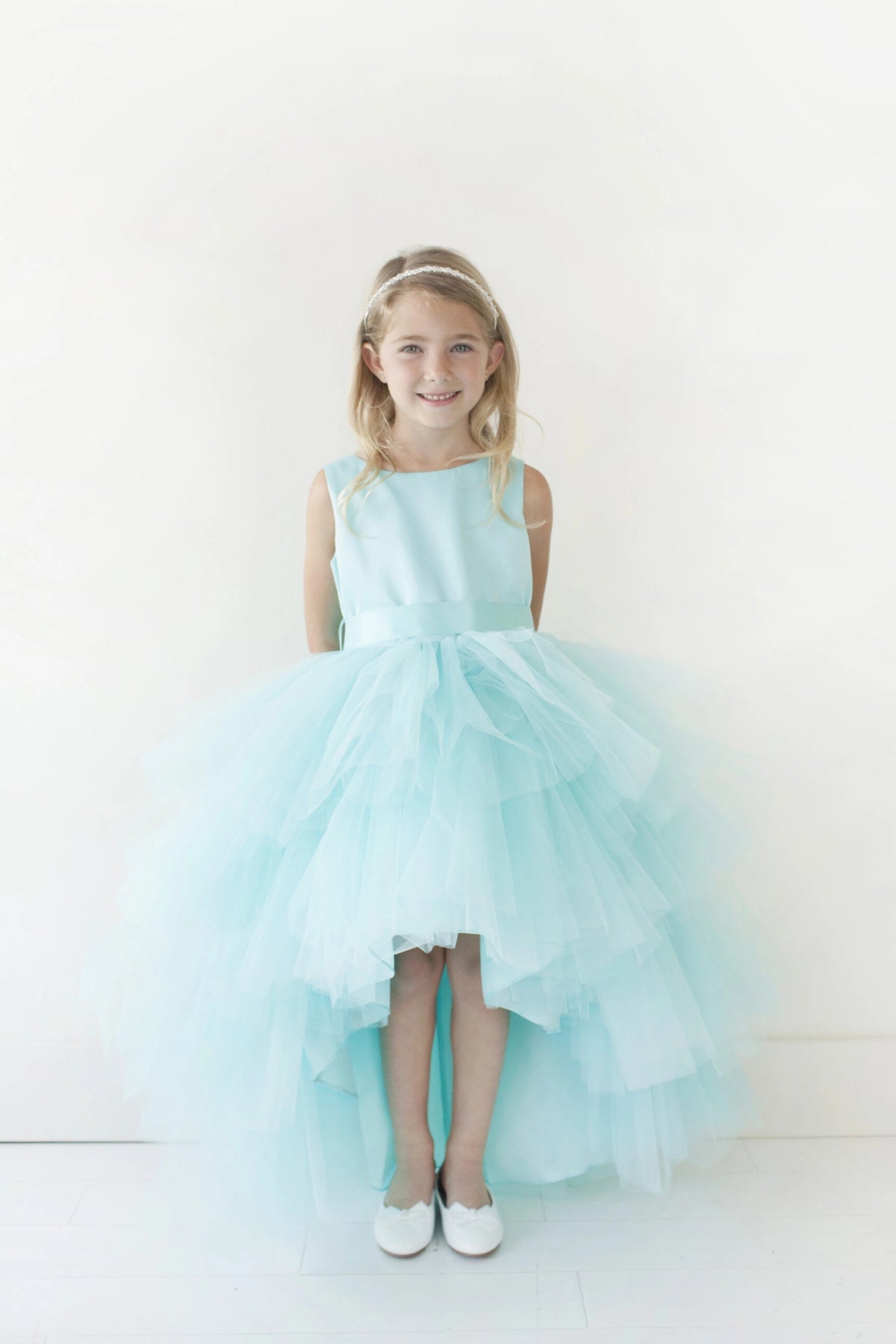 Aqua kids pageant dress featuring a satin bodice and layered high-low tulle.