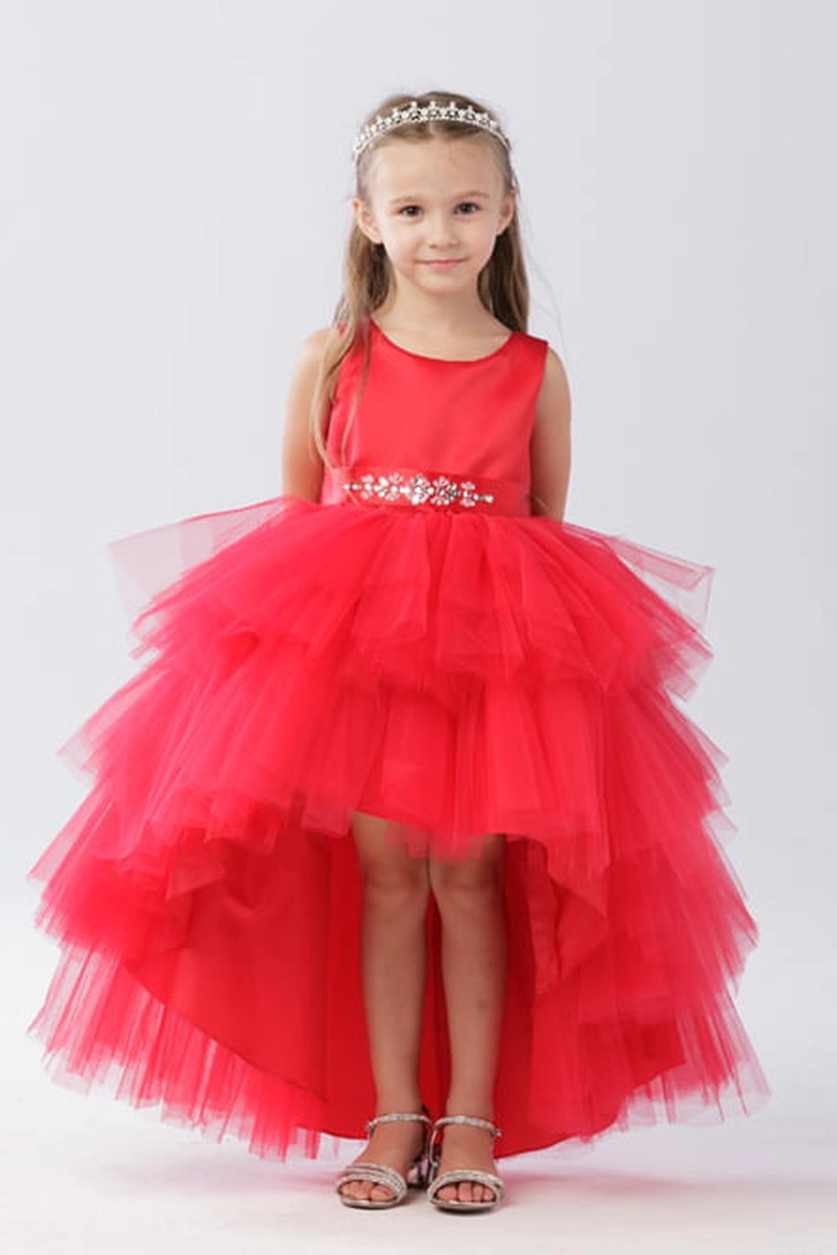 Seen from the front, this Red kids pageant dress displays a satin bodice and layered high-low tulle.