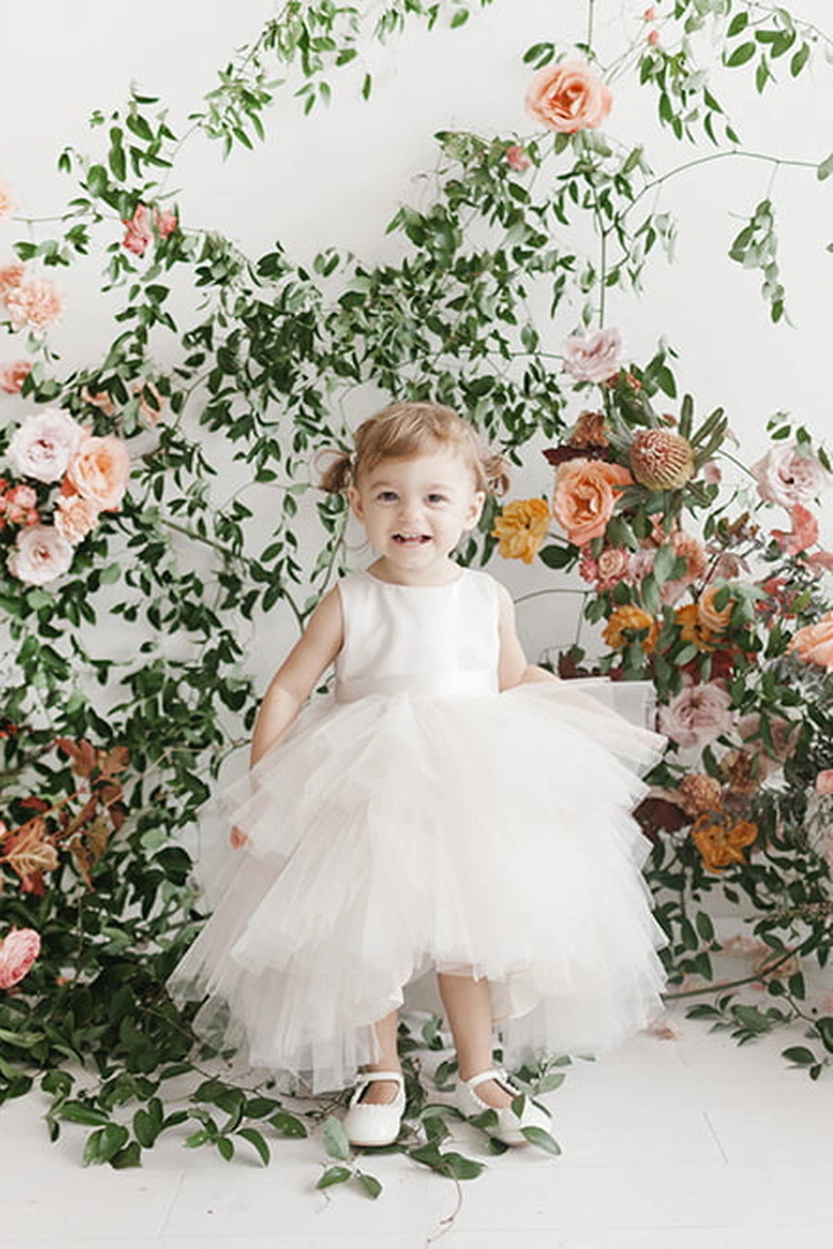 Visible details on the Ivory kids pageant dress include a satin bodice and layered high-low tulle.