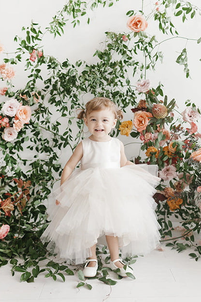 Visible details on the Ivory kids pageant dress include a satin bodice and layered high-low tulle.