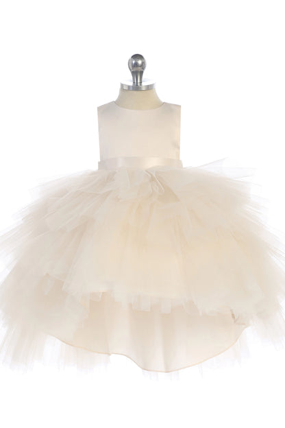 On the Ivory kids pageant dress, the detailing includes a satin bodice and layered high-low tulle.