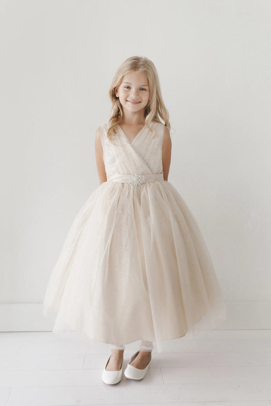 Ivory kids pageant dress featuring a ruched V-neckline and rhinestone brooch.
