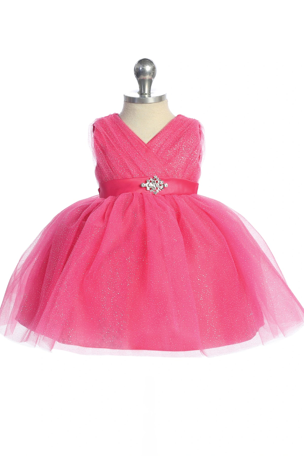 Visible details on the Fuchsia kids pageant dress include a ruched V-neckline and rhinestone brooch.