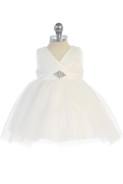Seen from the front, this Ivory kids pageant dress displays a ruched V-neckline and rhinestone brooch.