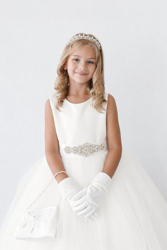 On this off-white flower girl dress, a beaded waist ornament is visible.