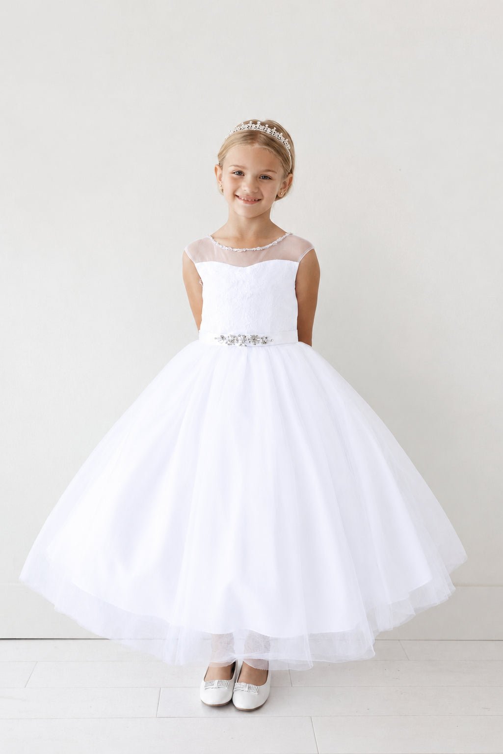 White flower girl dress with a softly flared tulle hem.