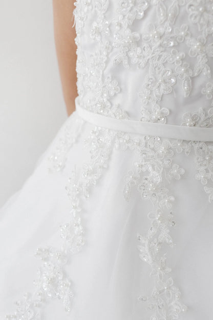 Pearl-like beads accent lace on the off-white flower girl dress's waist.