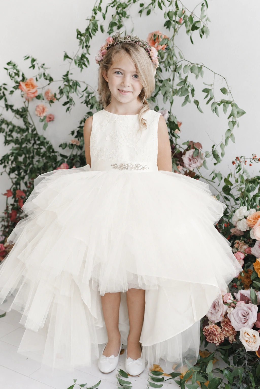 Lace-covered bodice: detail of the off-white flower girl dress.