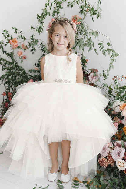 Lace-covered bodice: detail of the off-white flower girl dress.