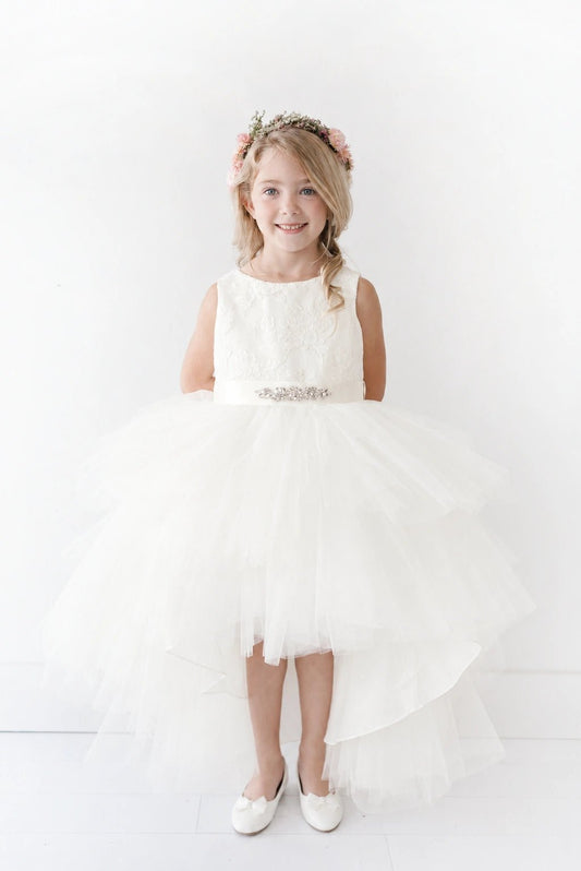 Detailed with gathered front tulle, this off-white flower girl dress.