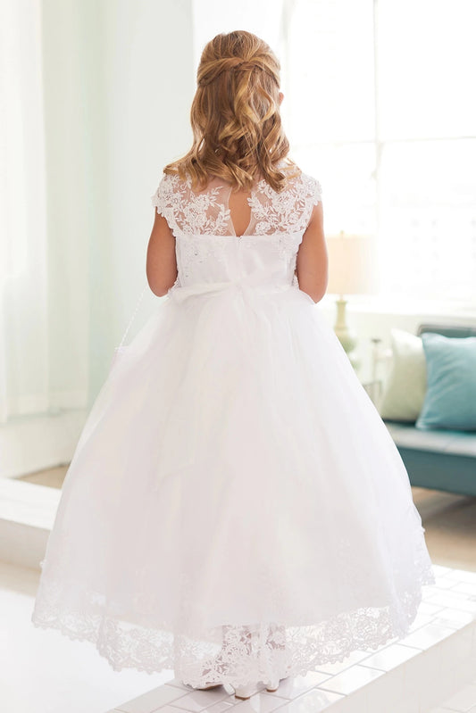 Lace-trimmed hem on a white flower girl dress.