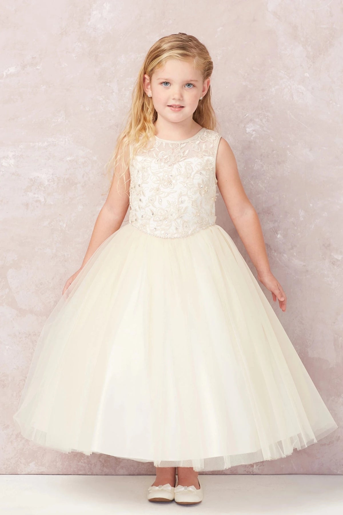 Floral lace bodice is visible on the champagne flower girl dress.