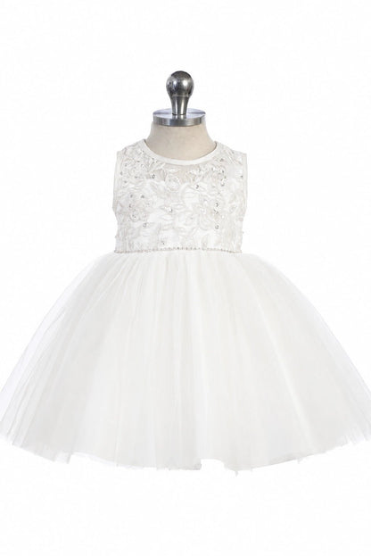 Featuring a gathered tulle skirt, a white flower girl dress.
