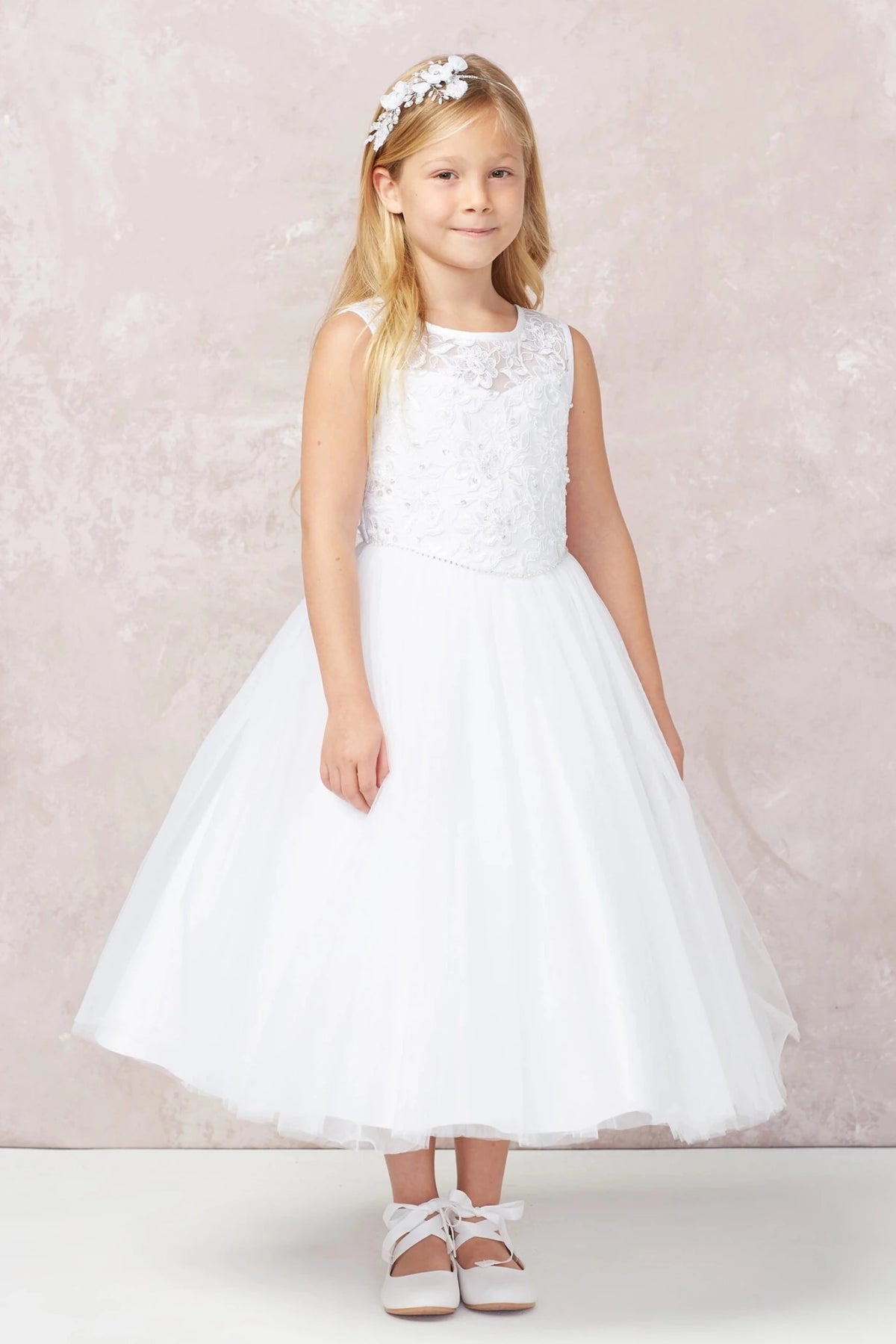 Highlighting a lace-covered bodice on a white flower girl dress.