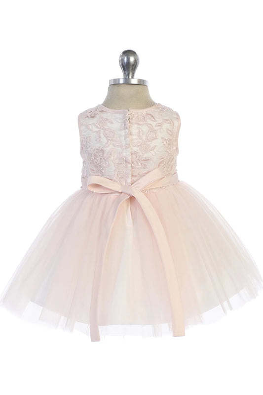 Featuring a tied satin back bow, a blush flower girl dress.