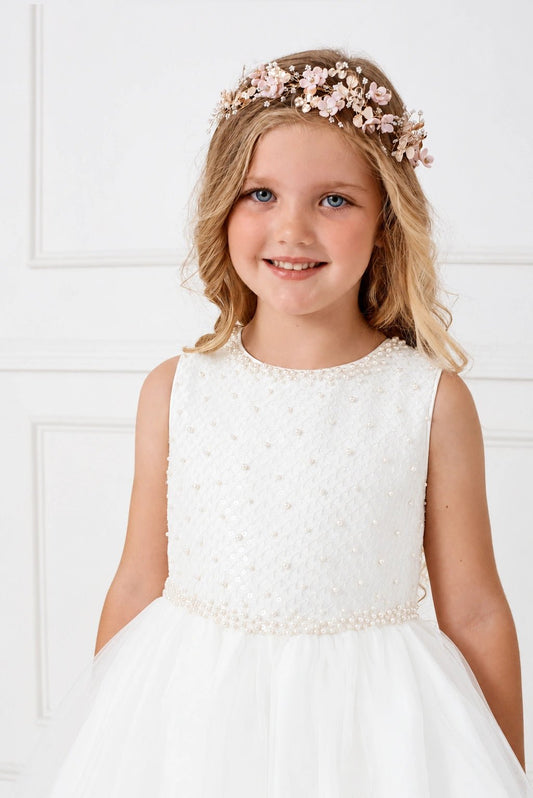 Shown here, an off-white flower girl dress with small pearl dots.