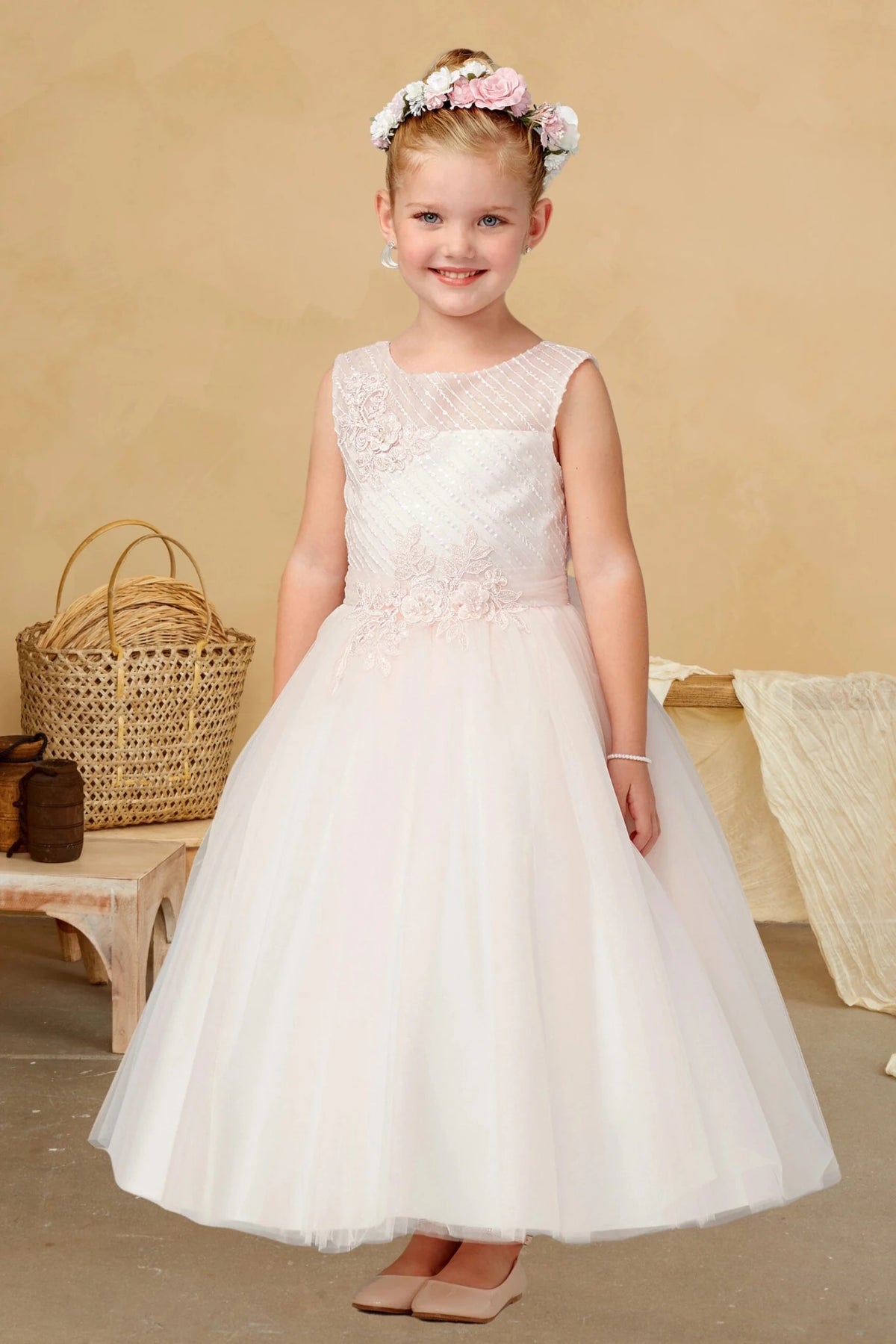 Diagonal pleated bodice on a blush flower girl dress.